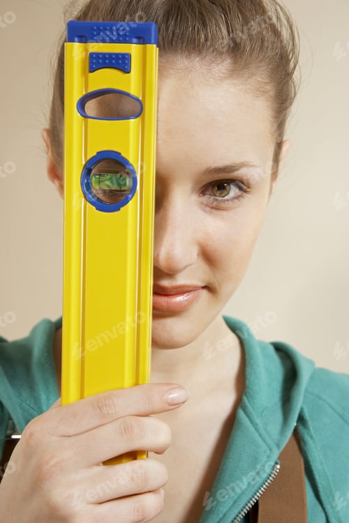 Preview: Portrait Of A Young Woman Holding A Spirit Level