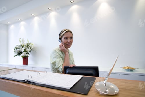 Preview: Receptionist Behind Desk With Headset