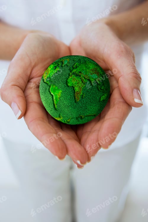 Preview: Environmental Concept With Woman Holding Grass Covered Globe