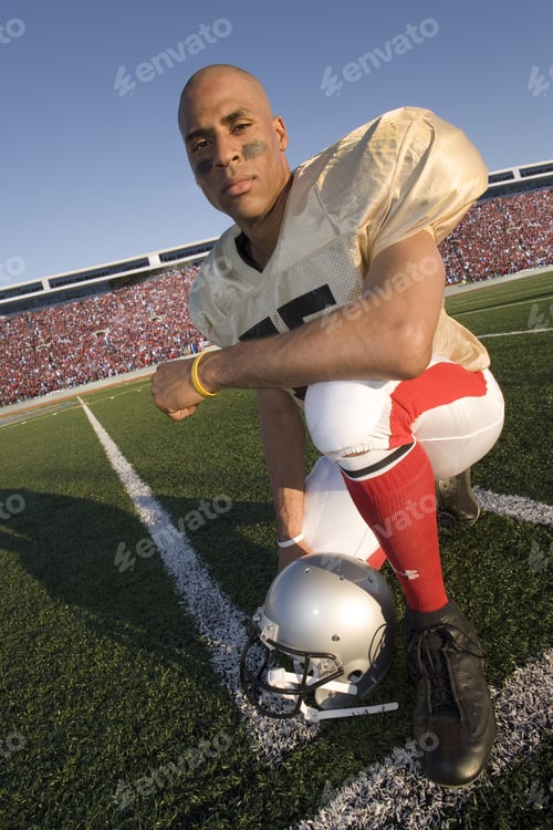 Preview: Portrait Of Football Player Kneeling On Field
