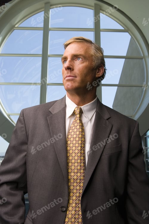 Preview: Businessman Standing In Front Of Round Window