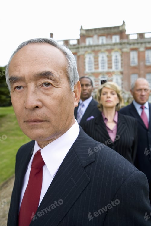 Preview: Mature Businessman And Colleagues By Manor House, Close-Up