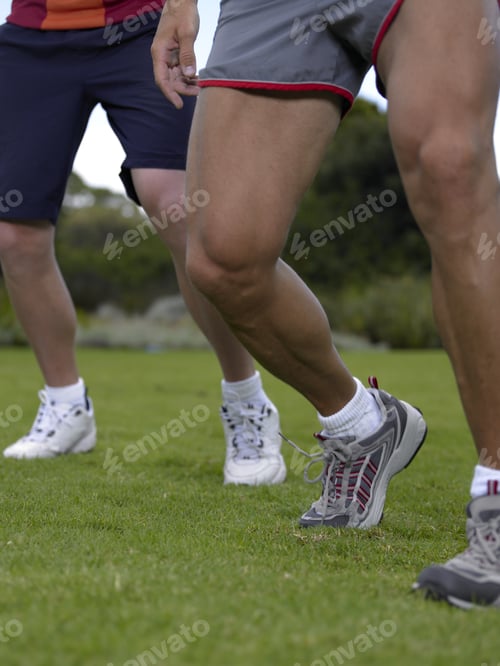 Preview: Low Section View Of Two Men Standing On A Lawn