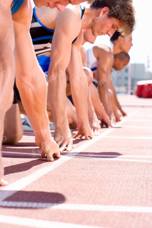 Preview: Competitive Male Athletes In Starting Blocks For Sprint Running Race