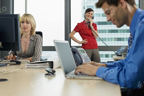 Preview: Three Business People Working In Office, Man Using Laptop, Woman Using Pc, Second Woman Using Phone