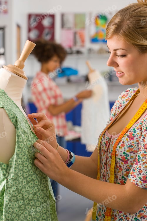 Preview: Female Textile Student Designing And Sewing Dress At College