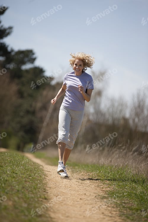 Preview: A Mature Woman Running Along A Country Path