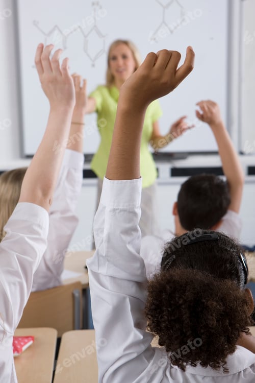 Preview: Students Raising Hands To Answer Teachers Question In Classroom