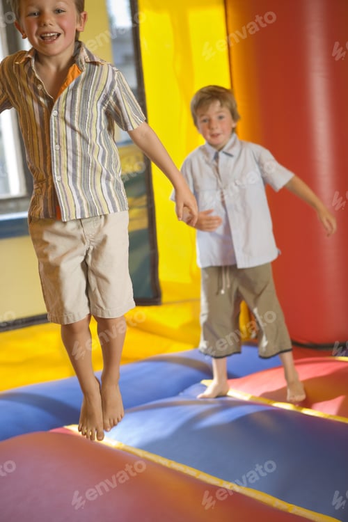 Preview: Two Boys Jumping On An Inflatable Bouncy Castle