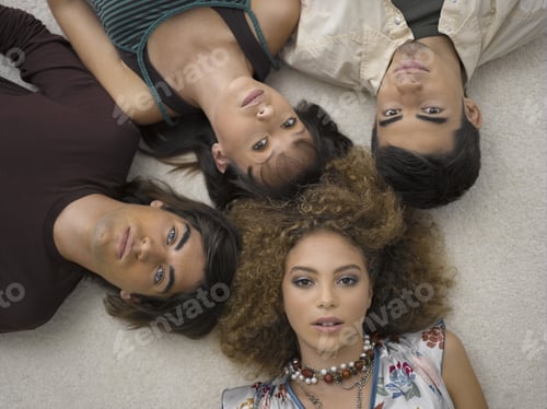 Preview: High Angle View Of Two Young Couples Lying Down