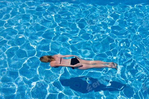 Preview: Active Woman Swimming Underwater In Outdoor Pool