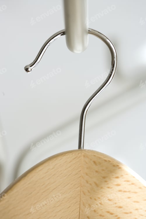Preview: Close Up Of Wooden Clothes Hanger Hanging In Closet