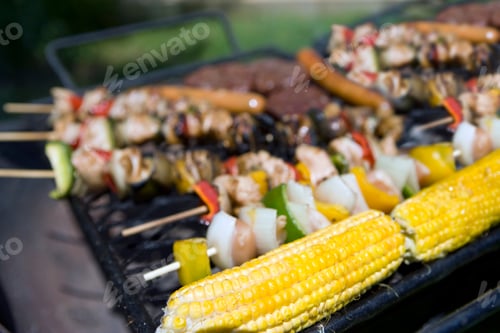 Preview: Close Up Of Corn On Cob And Kebabs Cooking On Barbecue Grill