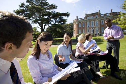 Preview: Businessmen And Women With Folders In Grounds By Manor House