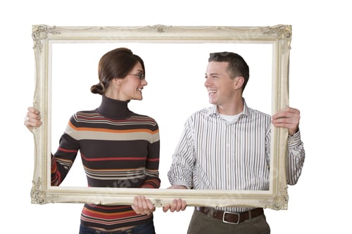 Preview: Smiling Couple Looking Through Empty Frame