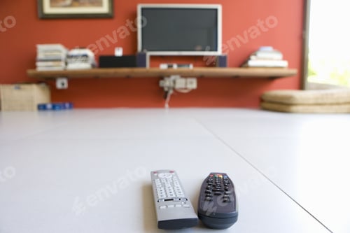 Preview: Two Remote Controls On Floor Infront Of Television
