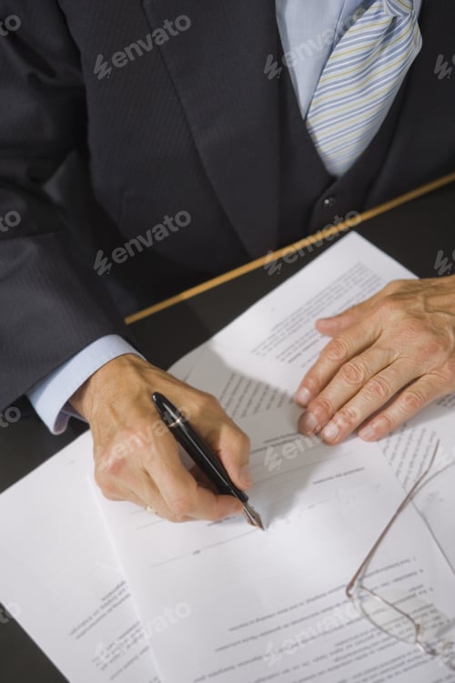 Preview: Mid Section View Of A Lawyer Filling A Form