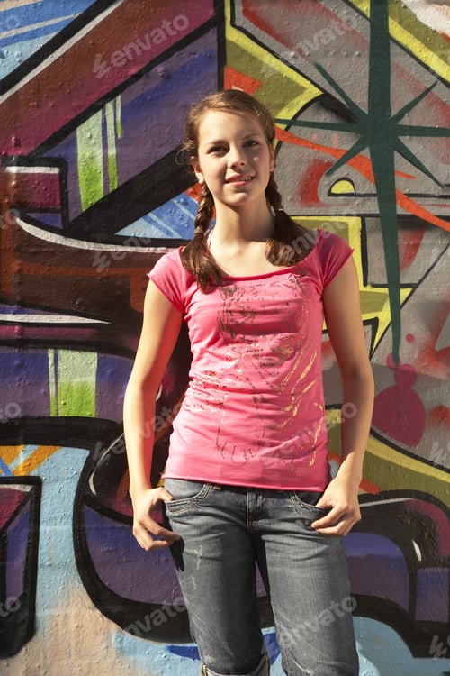 Preview: A Teenager Standing Against A Mural.