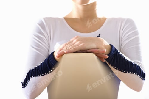Preview: Woman with Hands Resting on Gymnastics Balance Beam
