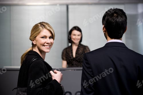 Preview: Man And Woman Arrive At Office Reception For A Business Meeting