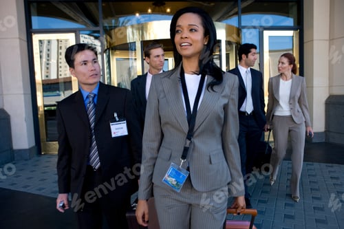 Preview: Group Of Business People At Conference Outside Hotel Building