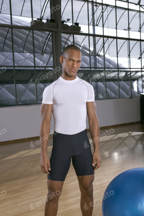 Preview: Man Standing Next To A Fitness Ball.