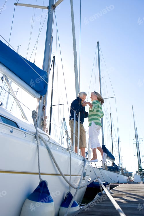 Preview: Senior Man Helping Woman To Board Yacht Moored At Marina Jetty