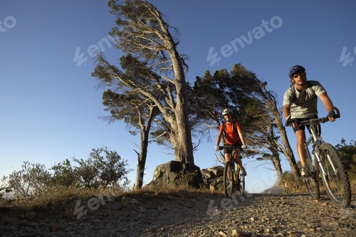 Preview: Couple Cycling Along Mountain Path, Front View, Surface Level