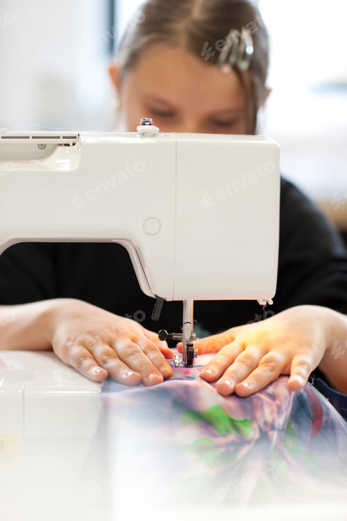 Preview: Female High School Student Using Sewing Machine In Textiles Class