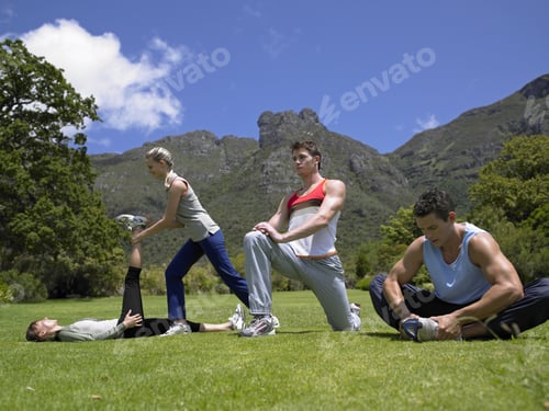 Preview: Two Young Couples Exercising On A Lawn