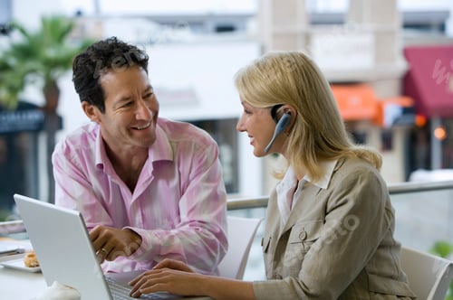 Preview: Business Colleagues Working On Laptop At Outdoor Table Businesswoman With Hands Free Phone Earpiece