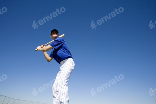 Preview: Baseball Batter, In Blue Uniform, Preparing To Hit Ball During Competitive Game, Front View, Low