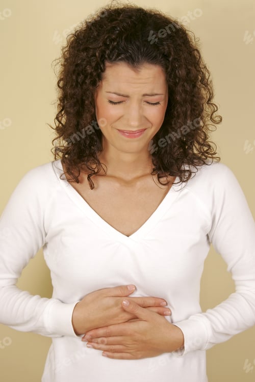 Preview: A Woman Holding Her Stomach In Pain.