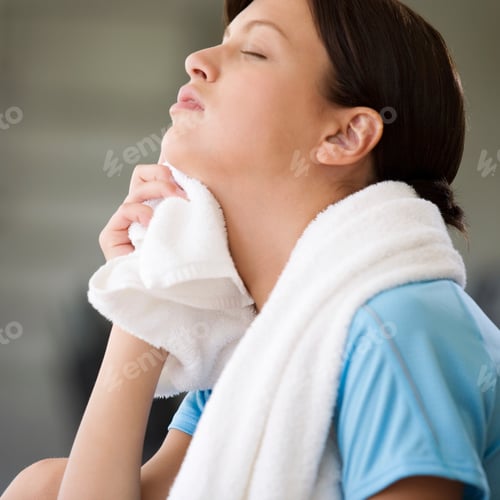Preview: Young Woman With Towel Resting After Exercise