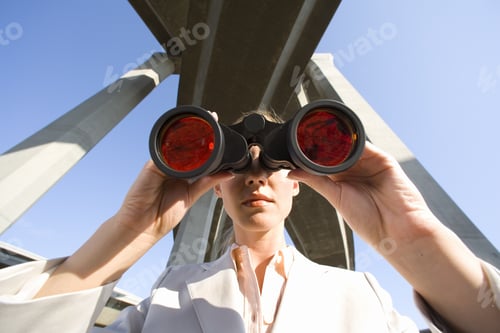 Preview: Businesswoman Using Binoculars Beneath Overpasses, Close-Up, Low Angle View
