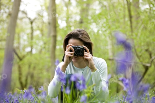 Preview: A Young Woman Photographing Bluebells, Smiling