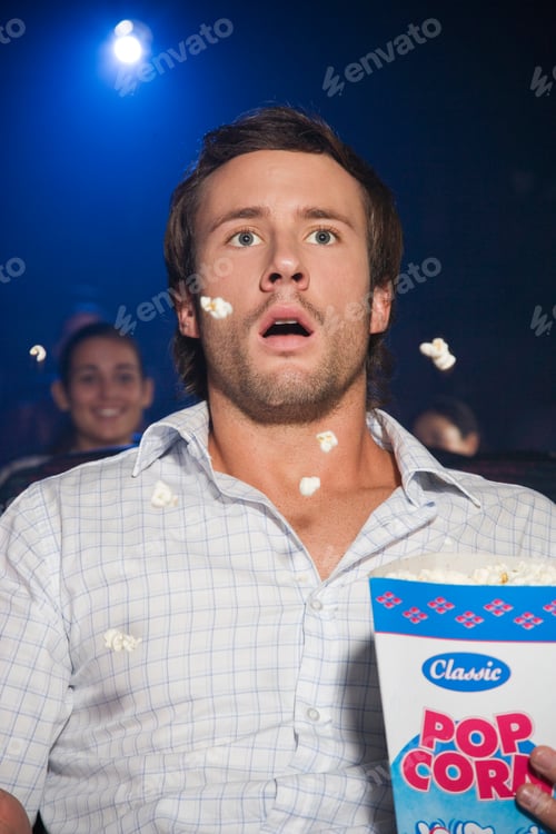 Preview: Frightened Man Watching Scary Film At Cinema Spilling Popcorn