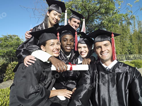 Preview: University Students In Graduation Gowns And Mortar Boards Holding Diplomas, Smiling, Portrait