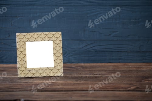 Preview: Golden Frame On Wooden Table On Blue Wooden Background