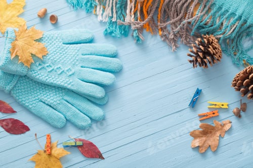 Preview: Blue Gloves And Autumn Leaves On Wooden Background