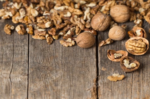 Preview: Walnut Kernels And Whole Walnuts On Rustic Old Wooden Table
