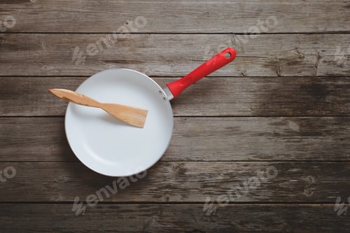 Preview: Frying Pan On Old Wooden Background