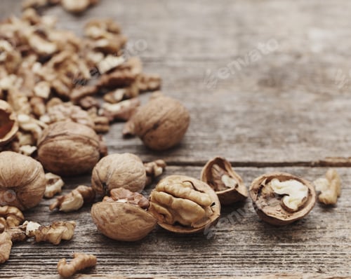 Preview: Walnut Kernels And Whole Walnuts On Rustic Old Wooden Table