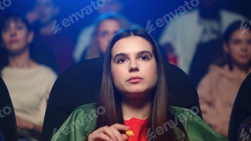 Preview: Frightened Girl Sprinkling Popcorn From Box In Movie Theater In Slow Motion. Portrait Of Young Lady
