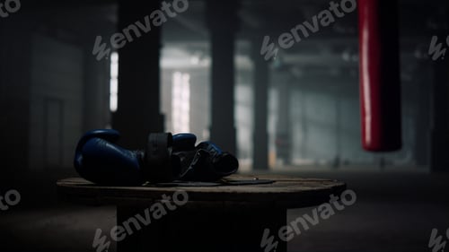 Preview: Box Sport Concept. Closeup Boxing Gloves Lying On Wooden Box In Empty Gym. Fitness Equipment In