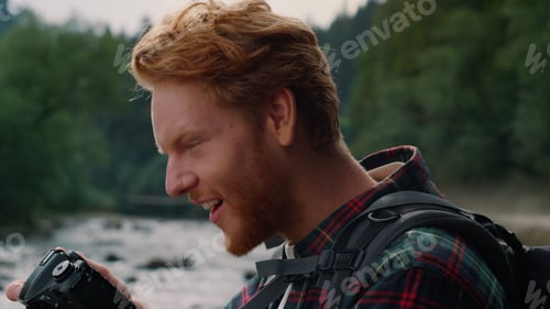 Preview: Smiling Man Looking Pictures On Photo Camera. Male Tourist Making Photos On Digital Camera