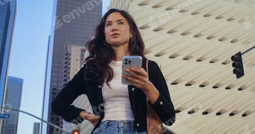 Preview: Beautiful Brunette Girl Using Smartphone Standing On Street Close Up. Young Confident Woman Looking