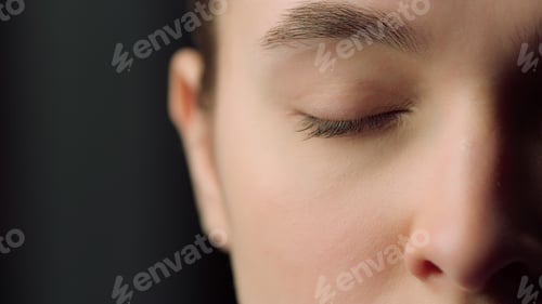 Preview: Extreme Close Up Of Half Face Shot Of Serious Female Face Indoors. Macro Of Tired Woman Eye Looking