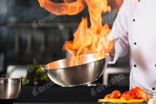 Preview: Chef Hands Hold Wok With Fire. Closeup Chef Hands Prepare Food With Fire. Cook Burn Food At