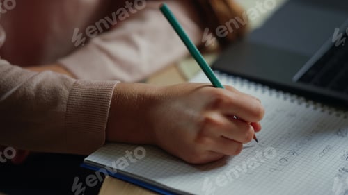 Preview: Closeup Girl Hand Solving Math Problems In Notebook Indoors. Portrait Of Thoughtful Child Doing